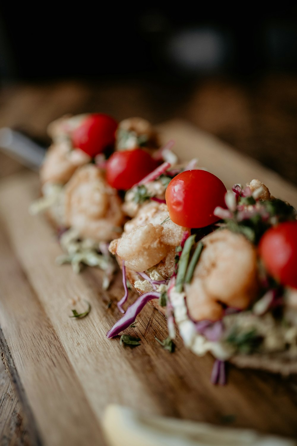 a wooden cutting board topped with lots of food