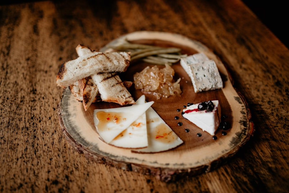 a plate of cheese and crackers on a wooden table