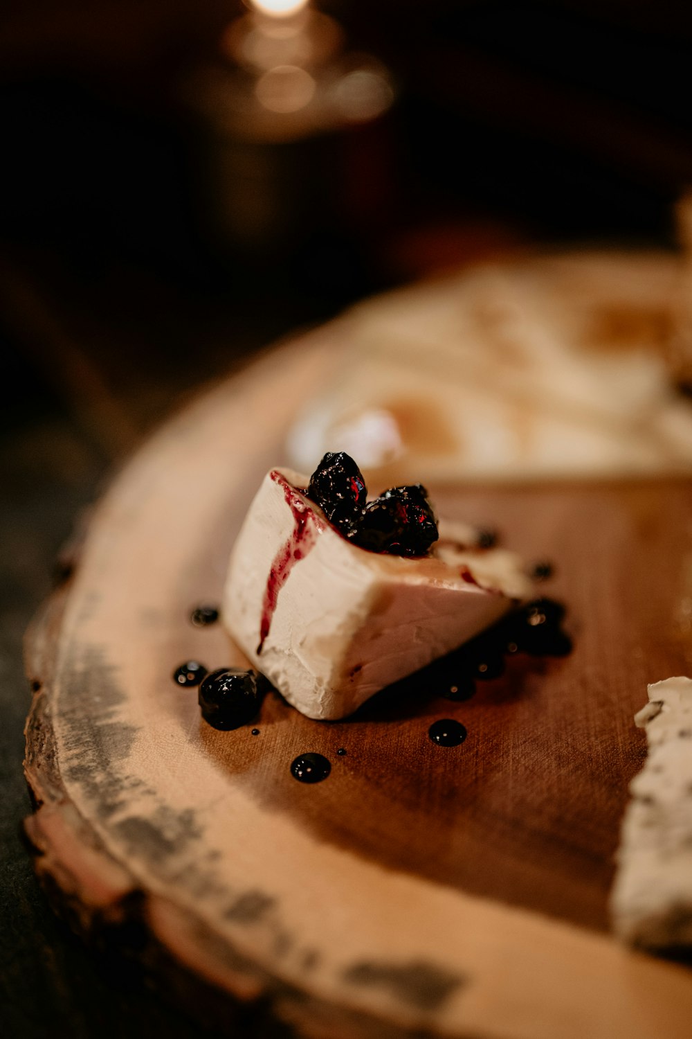 a piece of cheese with berries on top of it
