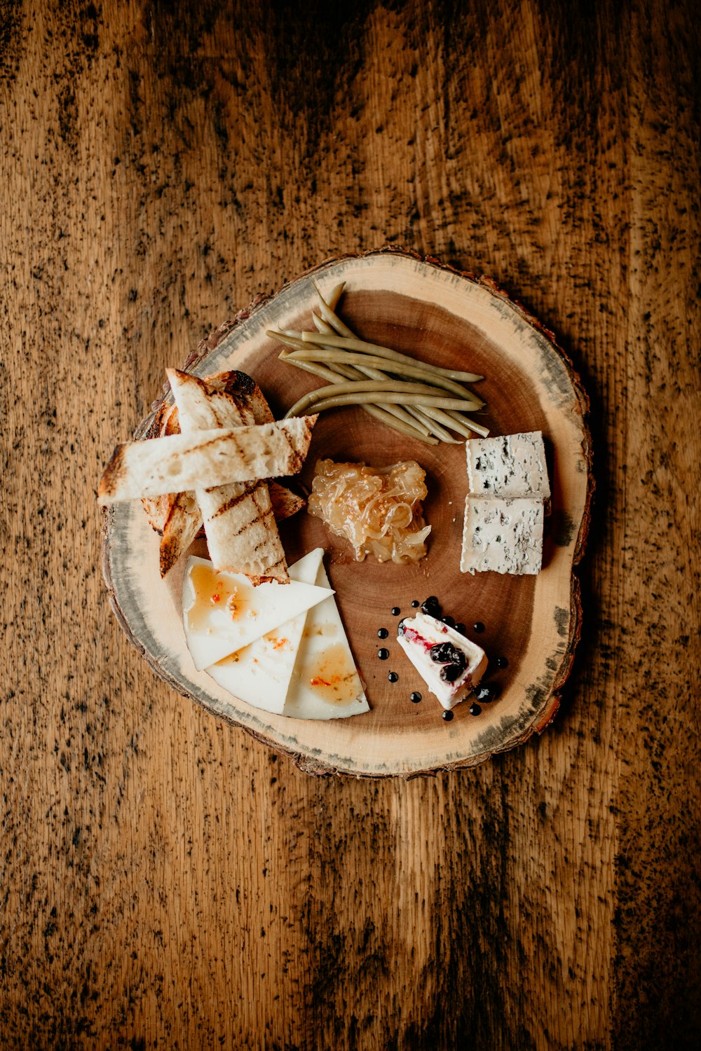 a plate of cheese and crackers on a wooden table