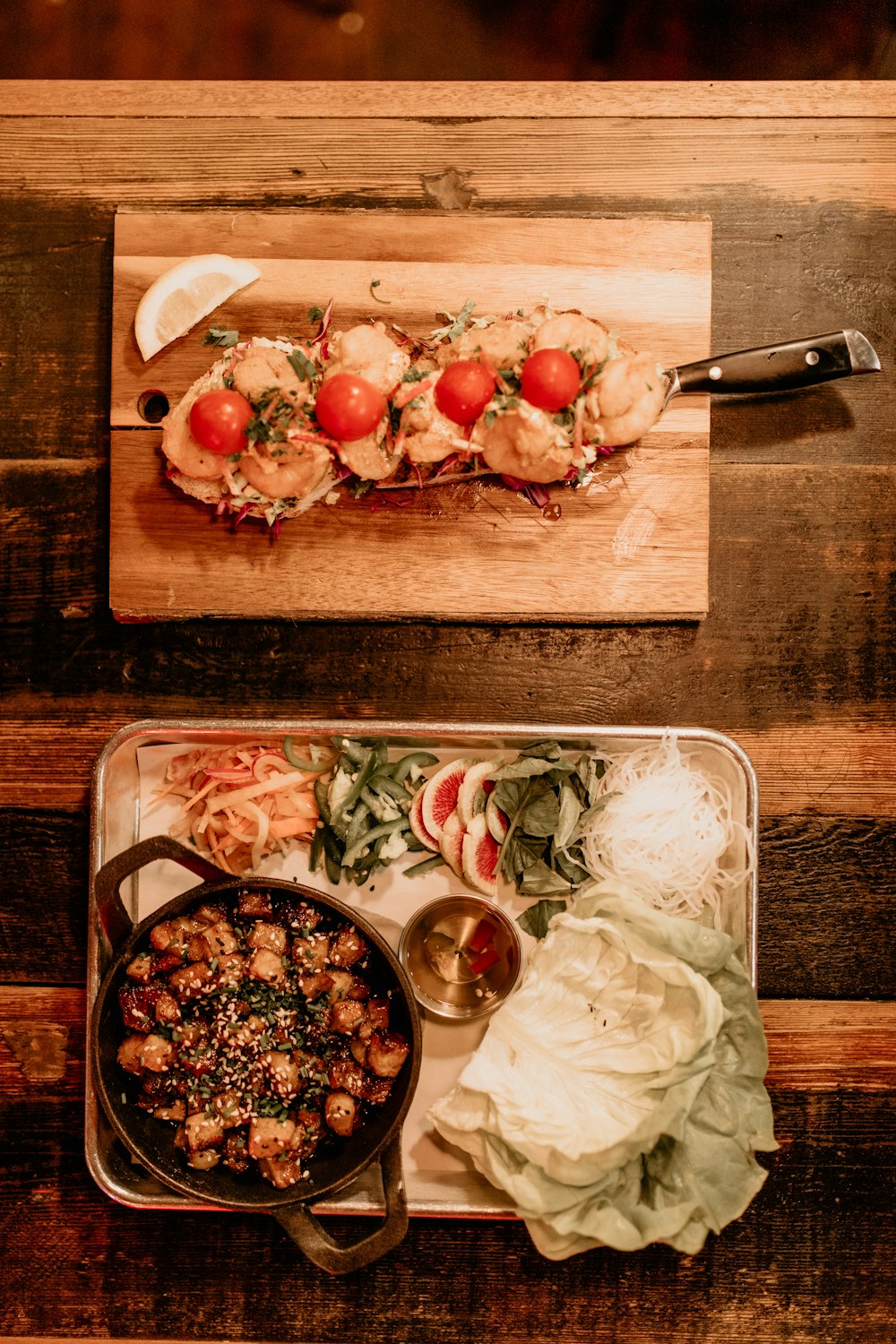 a wooden table topped with a tray of food