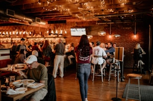 a group of people sitting at tables in a restaurant