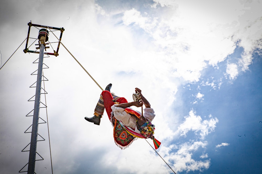 a man on a tightrope high up in the air