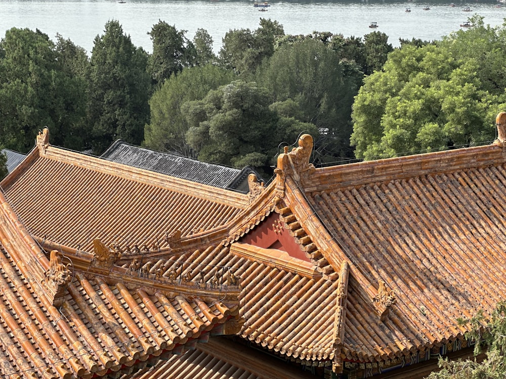 a view of the roof of a building with a lake in the background