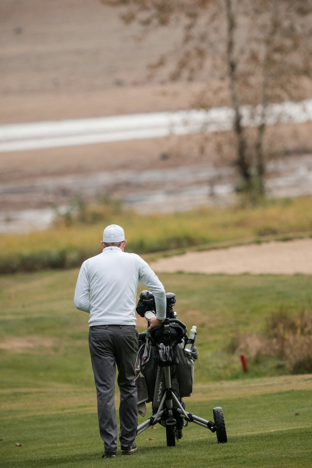 a man with a golf bag on a golf course