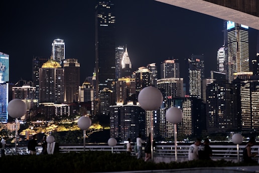 A dynamic business community networking event showing entrepreneurs exchanging ideas with modern city skyline background.