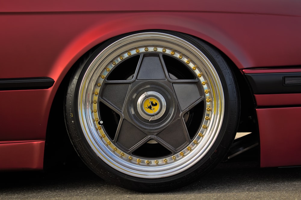 a close up of a wheel on a red sports car