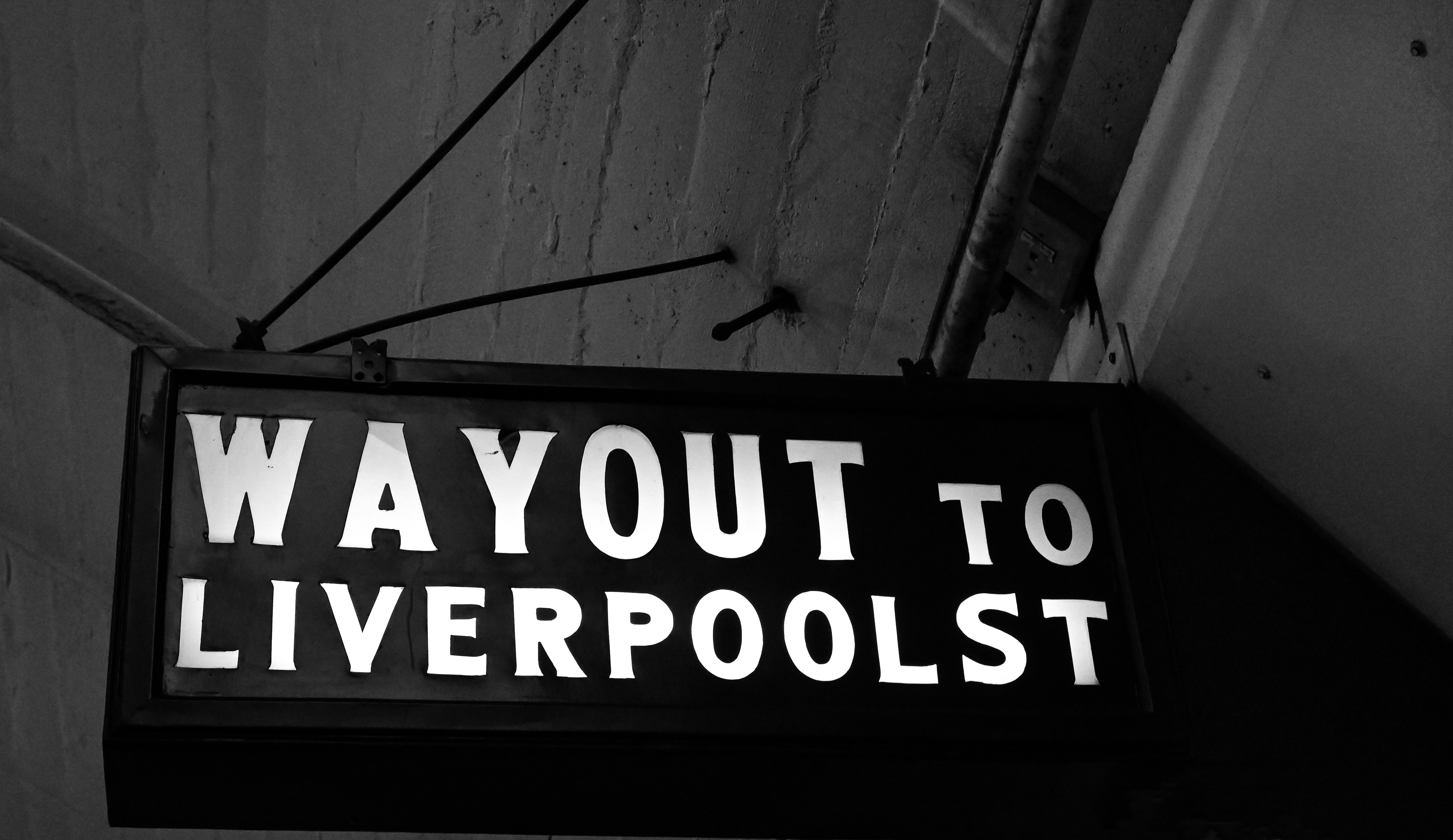 An old historic exit sign at Museum Station in monochrome. Many have been replaced with modern TfNSW signs; this is one of the few to remain.
