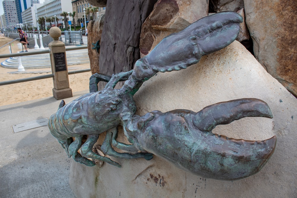 a statue of a crab on a rock