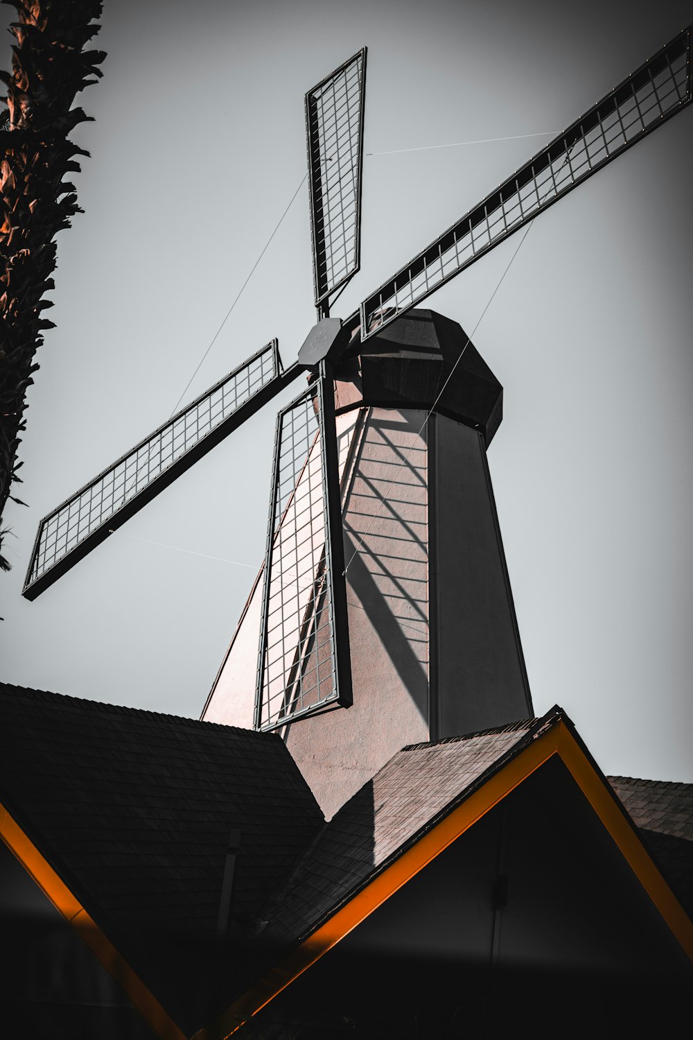 a windmill on top of a building with a sky background