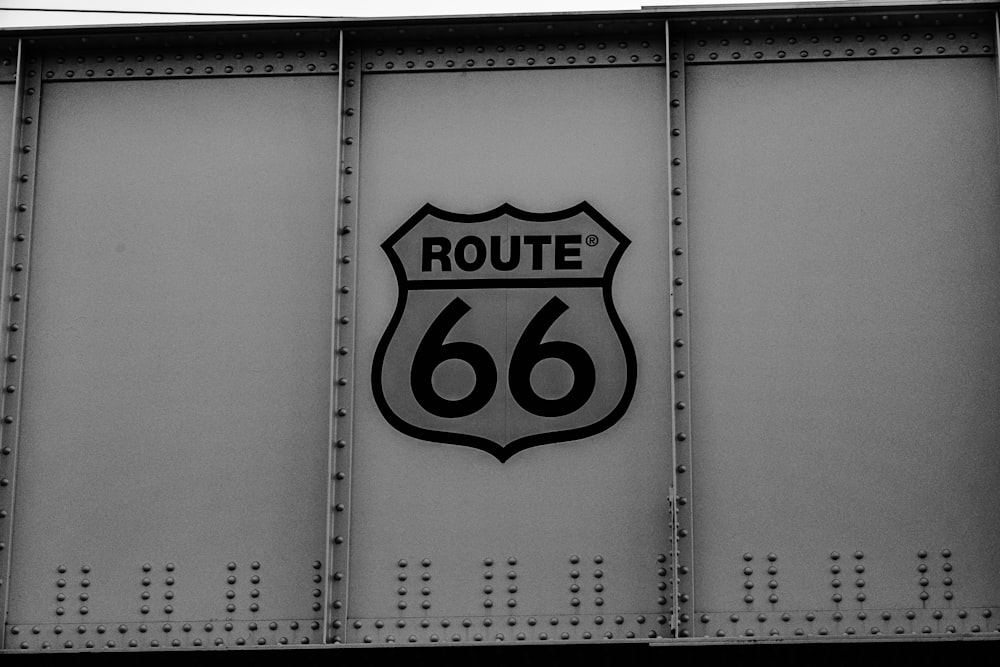 a black and white photo of a route 66 sign