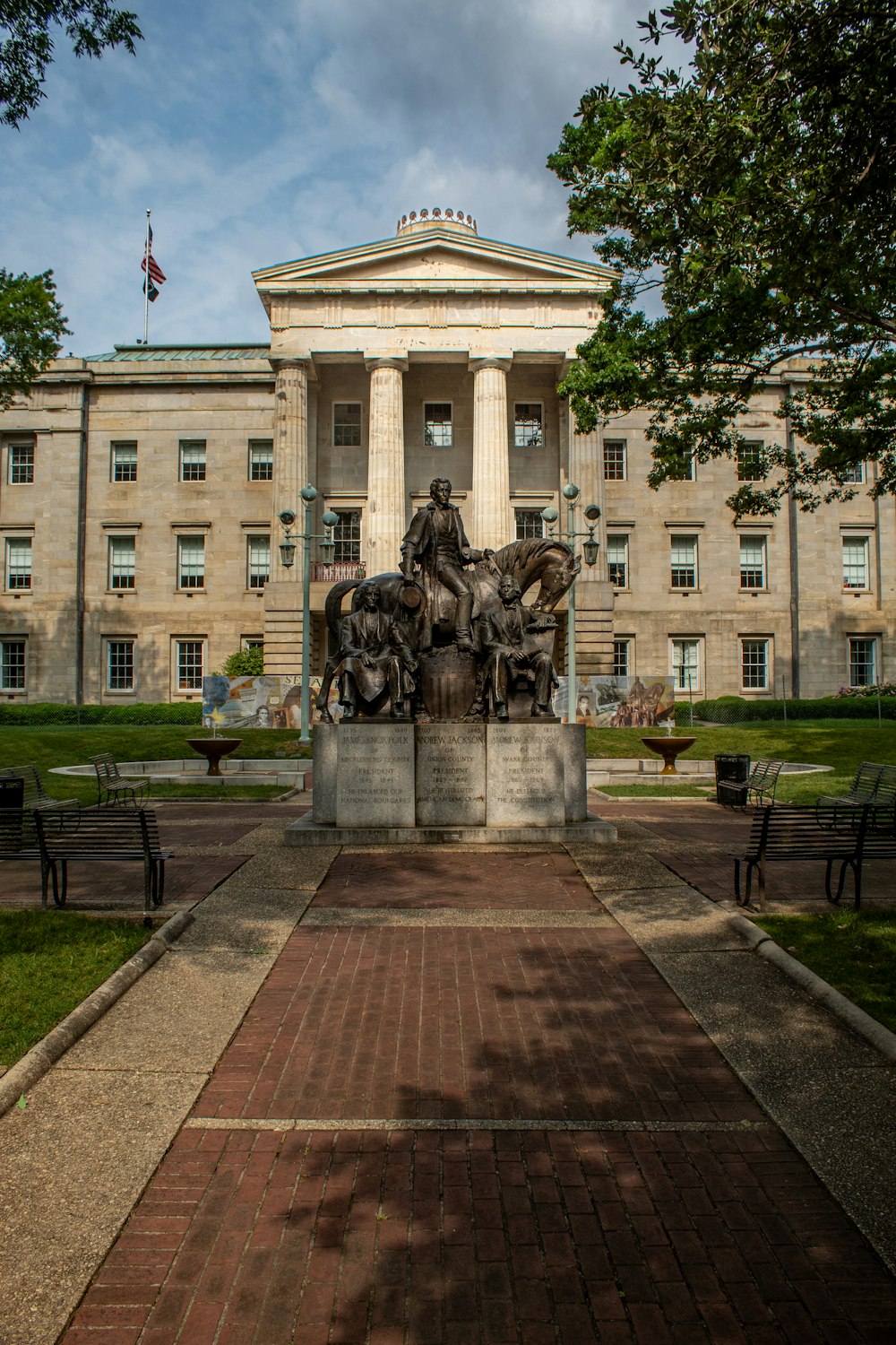 a statue of a man on a horse in front of a building