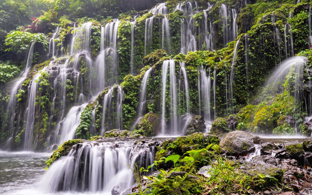 a large waterfall with lots of water cascading down it,