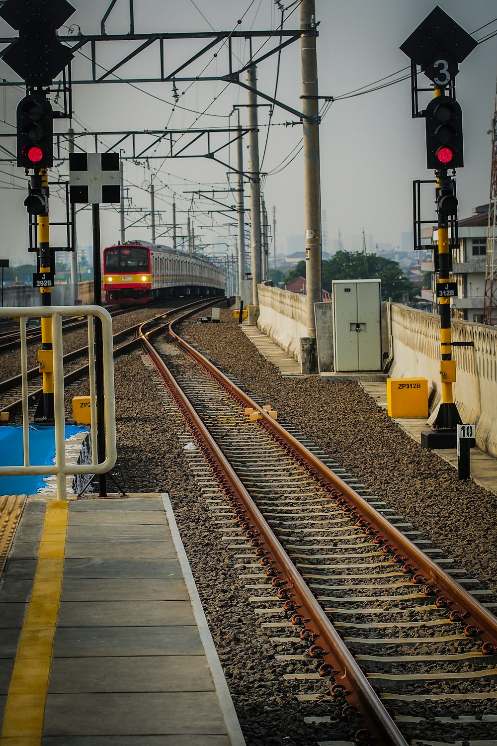 a train traveling down train tracks next to a train station