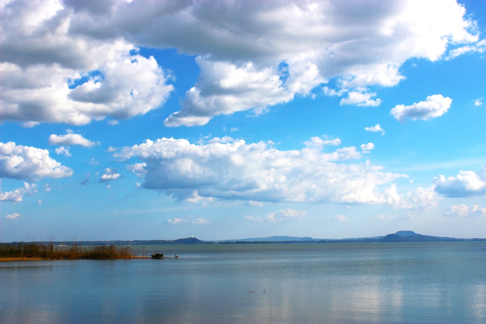 a large body of water with clouds in the sky