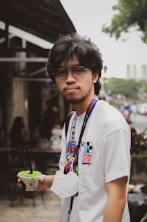 Young man holding zanvy cooler outdoors with cityscape background