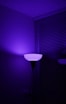 a purple light shines on a dark room