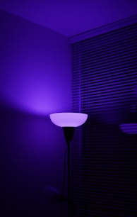 a purple light shines on a dark room