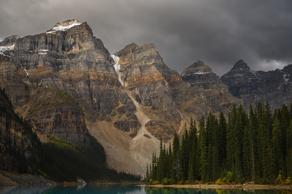 a mountain range with a lake in the foreground