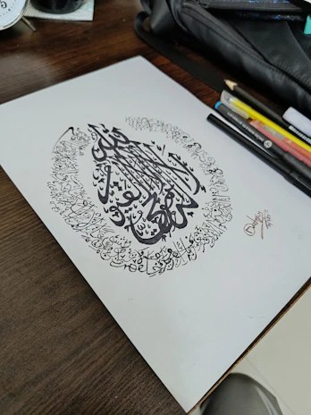 A collection of nikah pens and flower preservation art arranged artistically on a textured fabric.