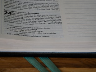 A close-up of an open book displaying text, with a section titled 'Jerusalem as a cooking pot.' The text includes numerical and paragraphed verses along with indented instructions.