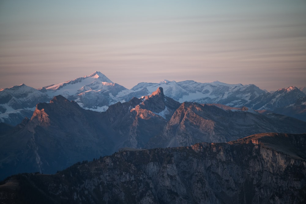 a mountain range with snow covered mountains in the background