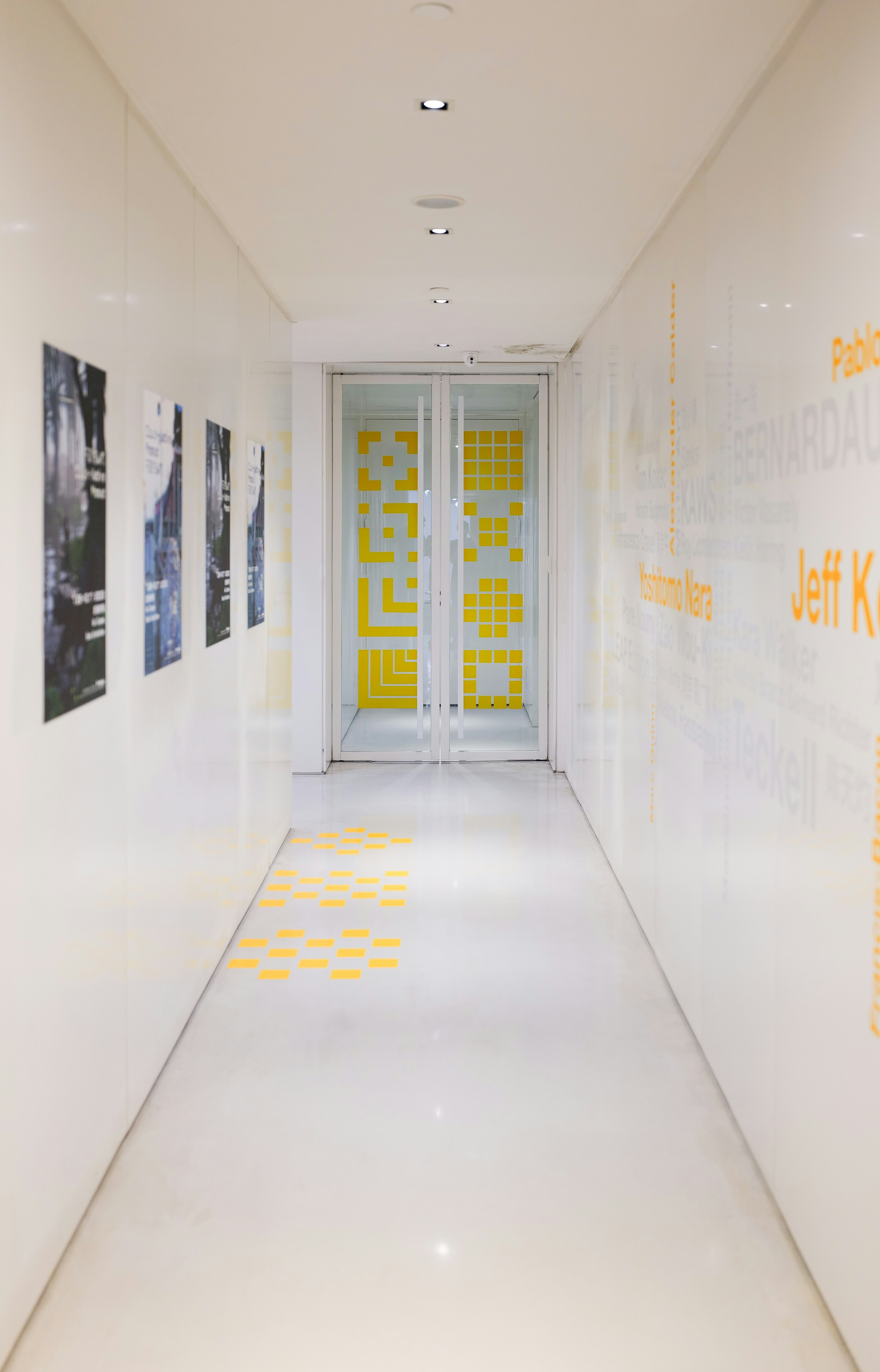 a long hallway with yellow and white walls