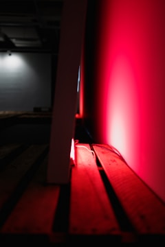 A striking black and red cinematic still capturing a dramatic, high-contrast brand film scene.