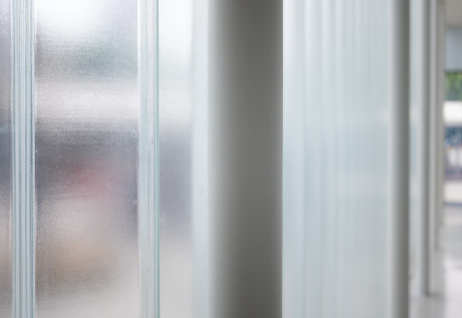 A pane of frosted glass obscuring the shapes behind it