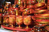 Array of colorful handcrafted items arranged neatly on a rustic shelf.