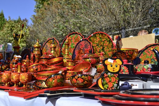 a table topped with lots of colorful plates and bowls