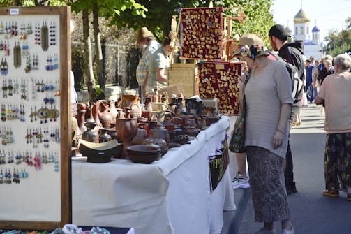 A bustling market scene with Katharina engaging with local artisans.