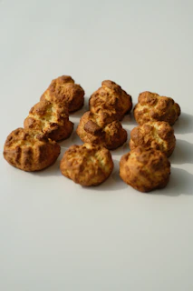 Array of gluten-free pastries arranged on a beige linen cloth with soft natural light.
