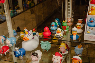 A colorful assortment of rubber ducks with fun stickers and display brackets.