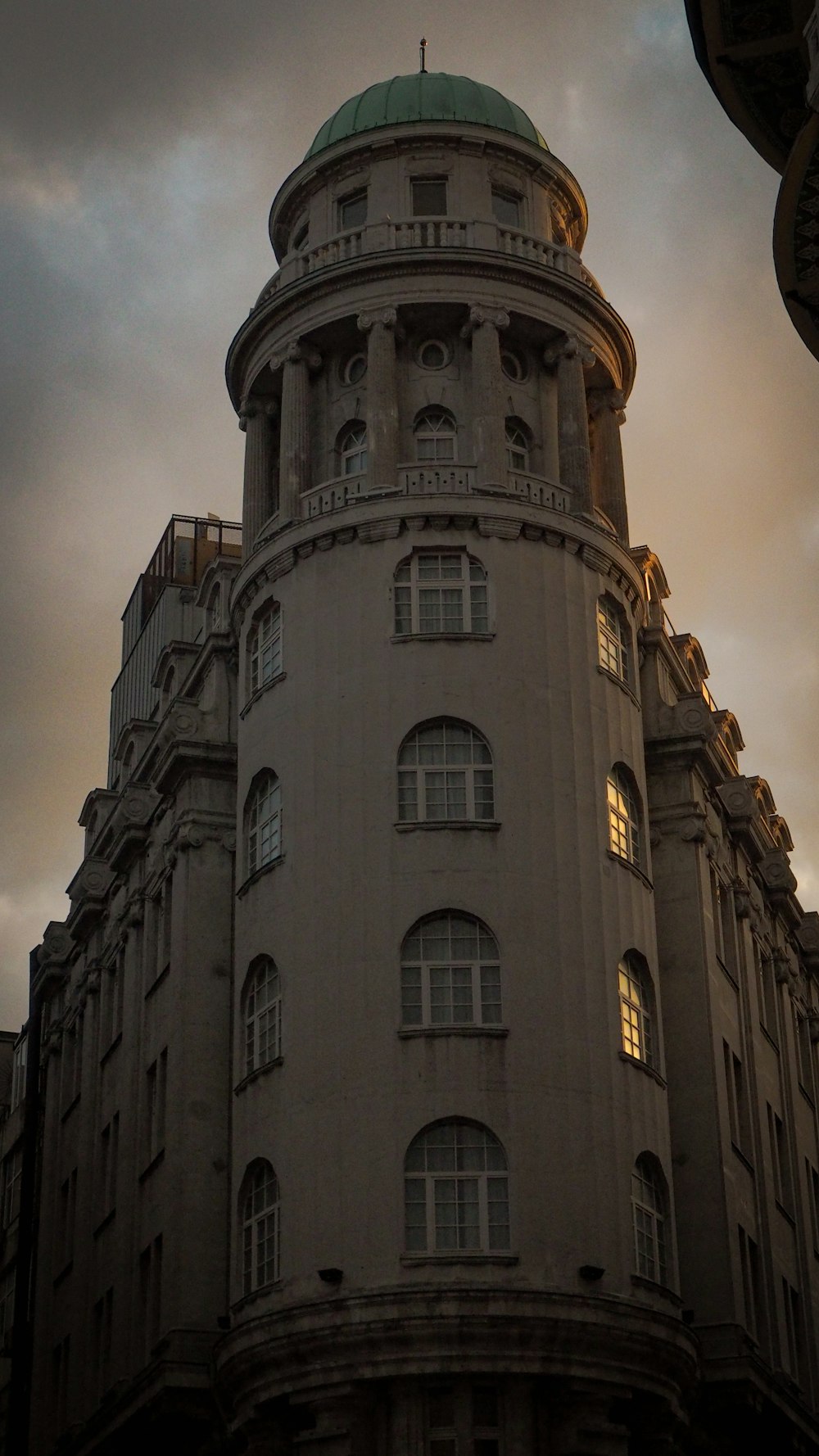 a tall building with a green dome on top