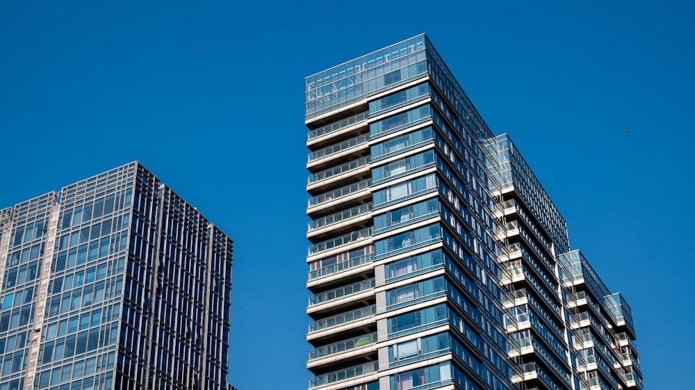 a couple of tall buildings sitting next to each other