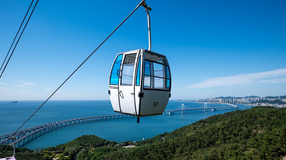 a cable car going over a large body of water