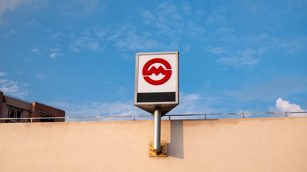 a red and white sign on the side of a building