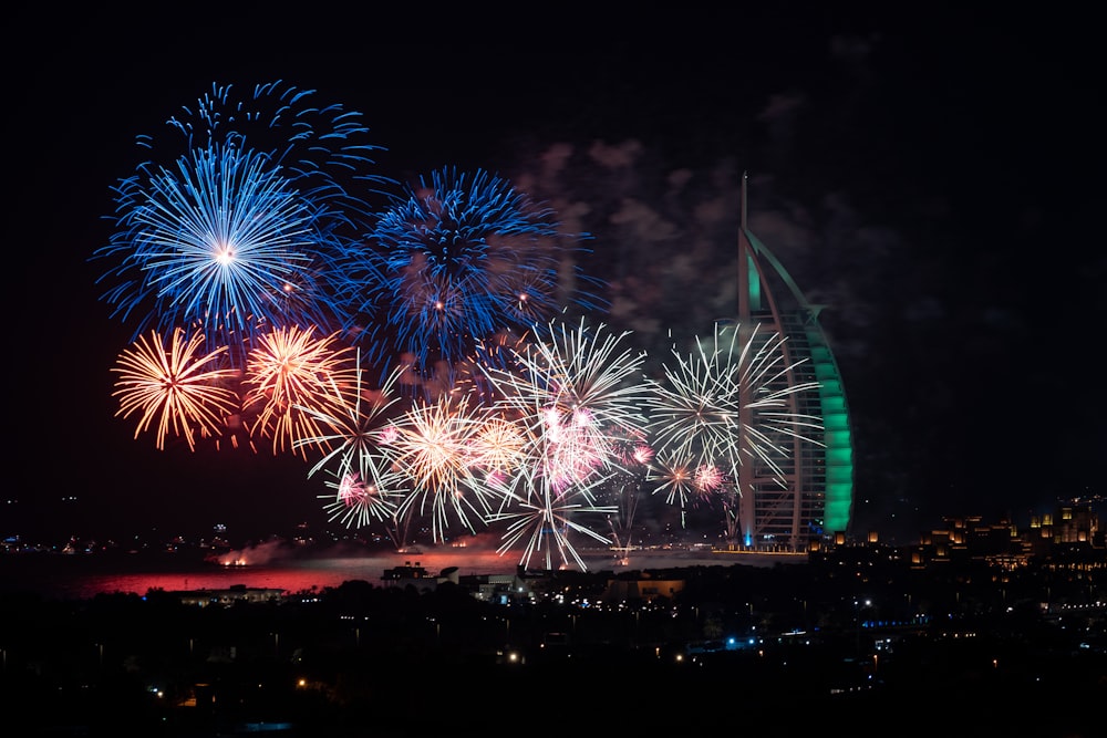 fireworks are lit up in the sky above a city