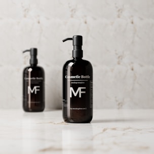 Two dark-colored pump bottles are positioned against a light, marbled background on a reflective surface. The bottles are labeled 'Cosmetic Bottle' and feature a minimalist design with clear, white text and the initials 'MF'.