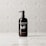 A glowing serum bottle elegantly displayed on a marble surface.