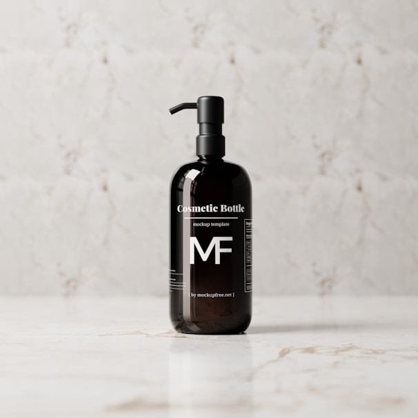 A sleek, black cosmetic bottle with a pump is placed on a light marble surface. The bottle features bold white text and branding, standing out against the reflective dark surface.