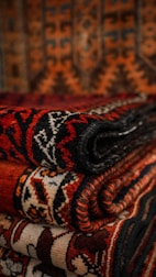 A stack of vintage quilt blocks showcasing varied textures and patterns.