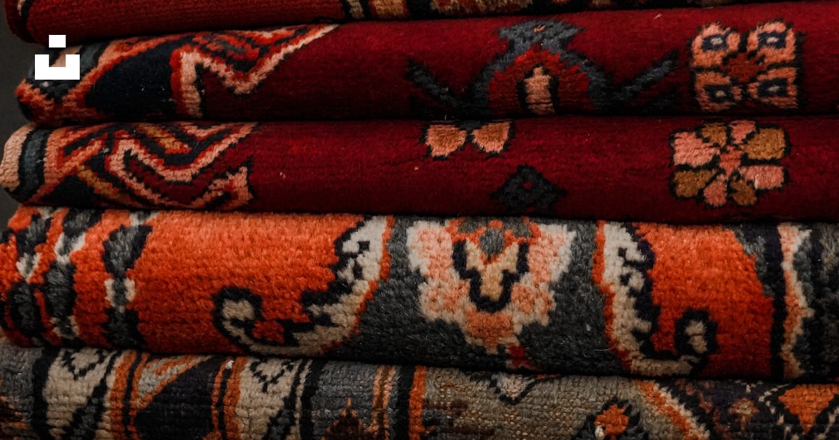 A pile of rugs stacked on top of each other photo – Free Iran Image on ...
