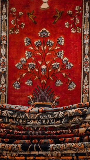A close-up of a richly woven French tapestry in deep burgundy and gold hues, capturing intricate floral patterns.