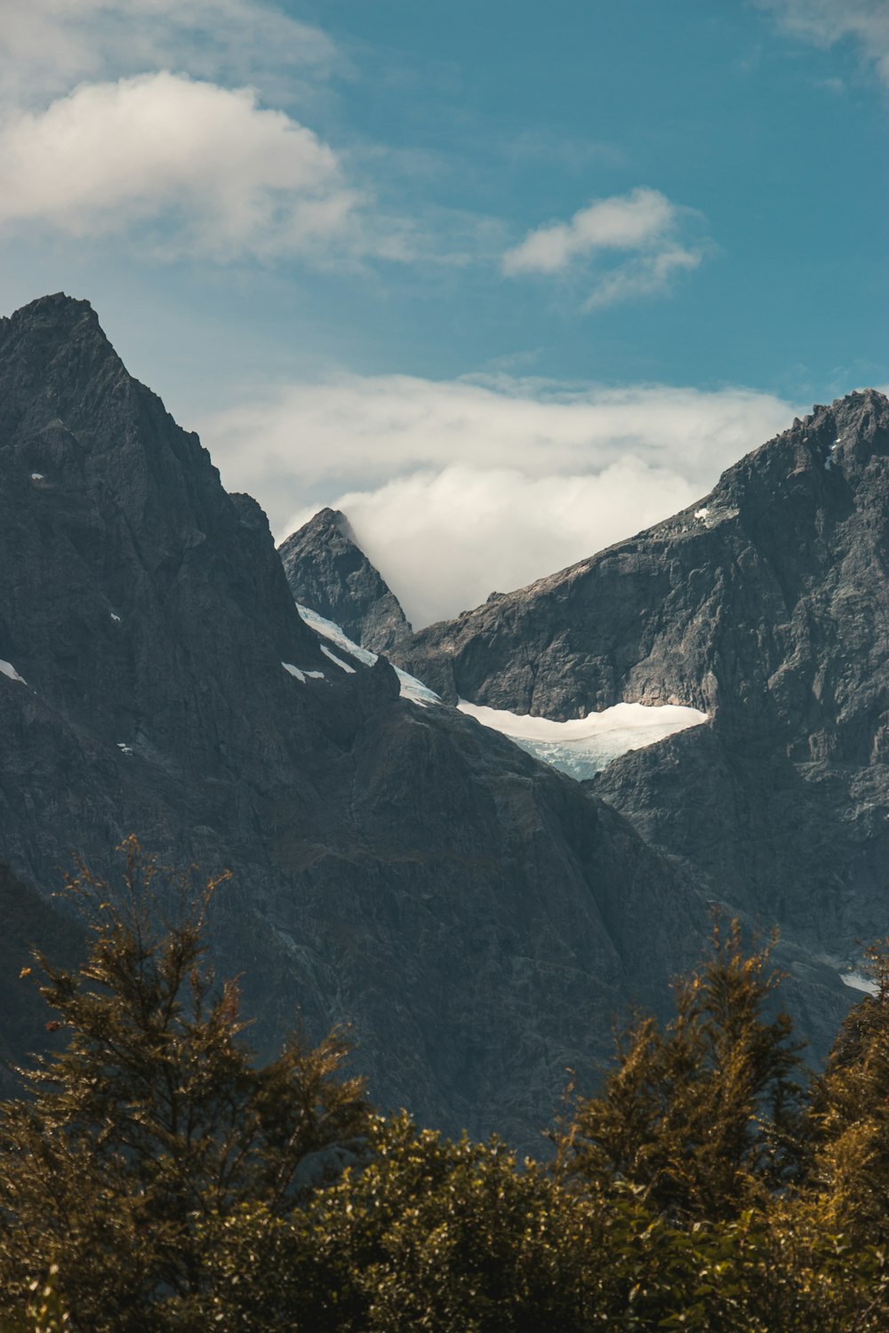 a view of a mountain range with snow on it