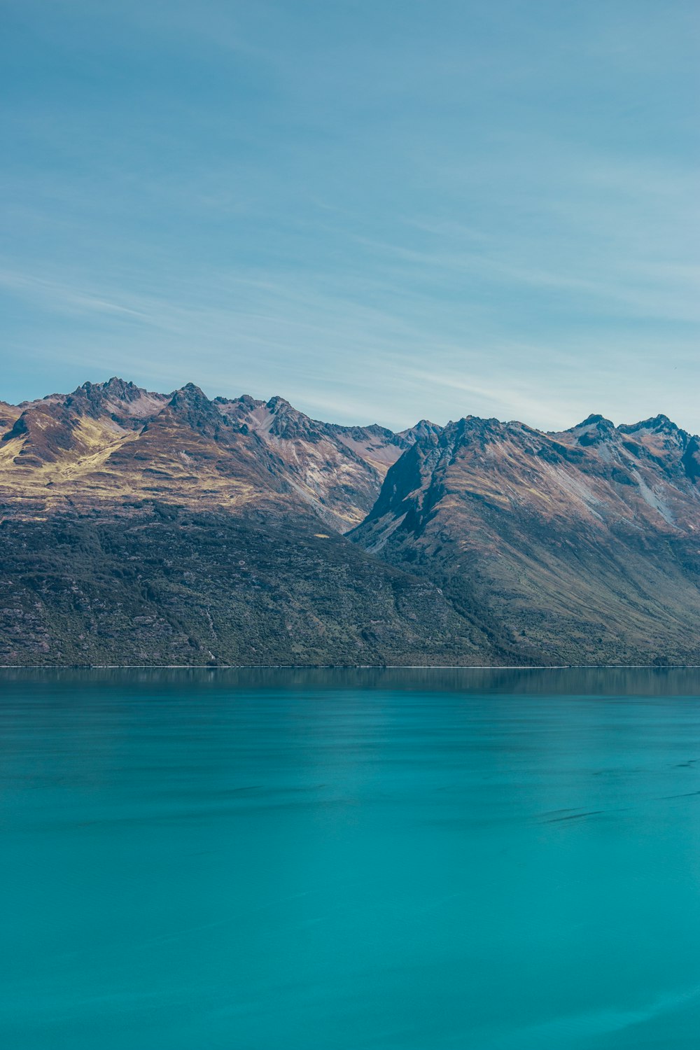 a large body of water with mountains in the background