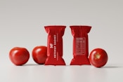 a bag of tomatoes next to three bags of tomatoes
