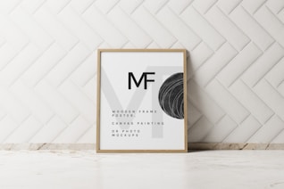 a picture frame sitting on top of a counter next to a wall