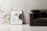Close-up of a minimalist geometric canvas print hanging above a sleek sofa.